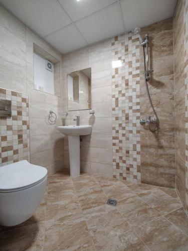 a bathroom with a sink and a toilet and a shower at Hotel Joker in Lozenets