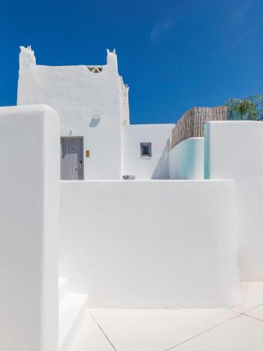 a white building with a blue sky in the background at Axel Beach Mykonos - Adults Only in Mýkonos City