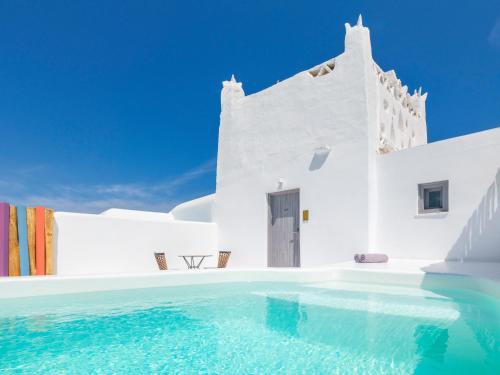a swimming pool in front of a white building at Axel Beach Mykonos - Adults Only in Mýkonos City