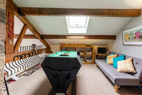 a room with a pool table and a couch at The Croft Holiday Cottage - AA Accredited, Country Cottage in Colne