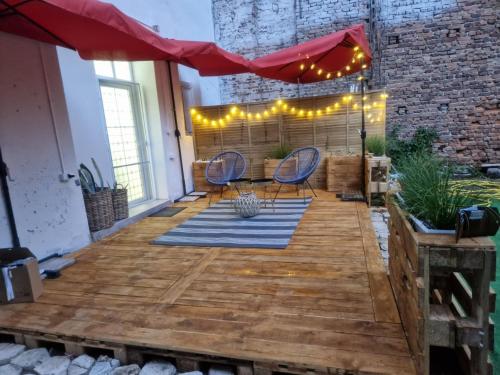 a patio with a table and chairs on a wooden deck at Villa al Tempio in Pazardzhik