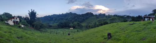 a green hill with a house on top of it at Casa de campo vacacional "Tres Soles" en Xico, Veracruz in Xico