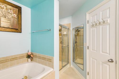 a bathroom with a shower and a white tub at Anchorage Home about 8 Mi to Downtown! in Anchorage