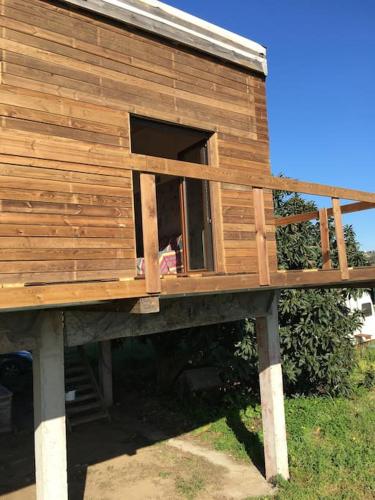 a wooden house with a window on a stand at Villa Mezanine in Santarém