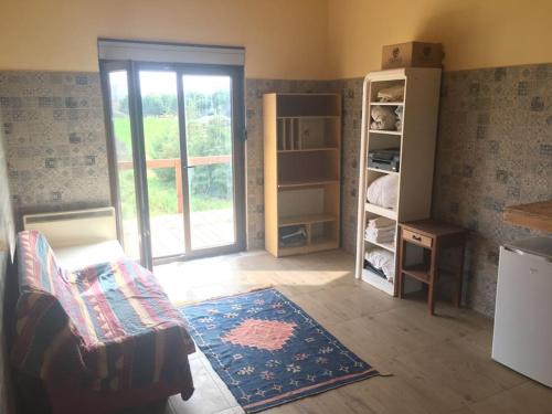 a room with a living room with a door and a rug at Villa Mezanine in Santarém