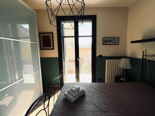 a bedroom with a bed and a large window at Casa dello Chef, Il loft nel cuore della città in Lecce