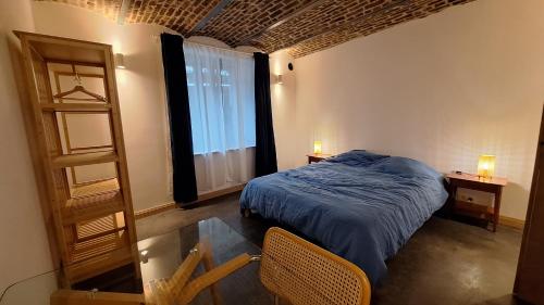 a bedroom with a bed and a glass table at Bed and breakfast Le fourchu fossé in Liège