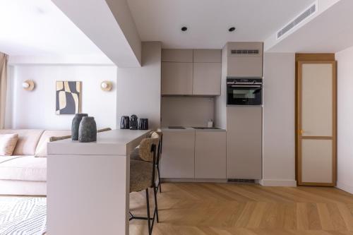 a kitchen and living room with a bed and a table at Quartier Libre Opera in Paris