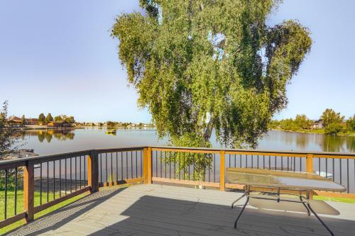 a bench sitting on a deck next to a lake at Lakefront Fairbanks Home with Private Beach! in Fairbanks