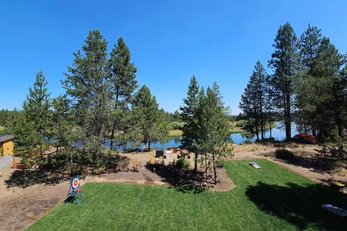 an aerial view of a park with trees and a lake at Beautiful Riverfront Near Mt Bachelor with Hot Tub in Bend