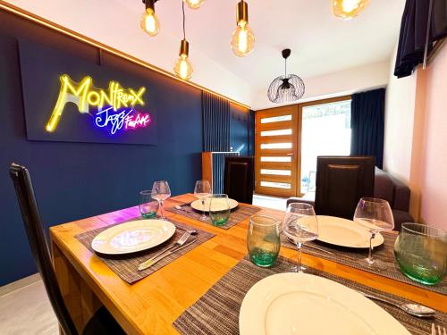 a dining room with a table with wine glasses at Close to Lake & Chillon Castle, New & Comfortable in Veytaux