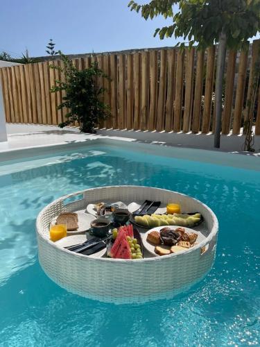 a circular table of food in a swimming pool at Axel Beach Mykonos - Adults Only in Mýkonos City