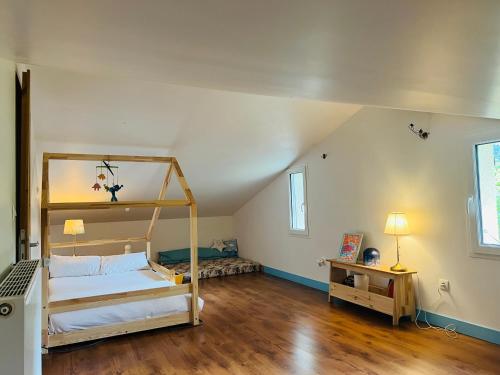 une chambre avec deux lits superposés et un plancher en bois dans l'établissement La grande maison de la campagne, au pieds des Pyrénées Ariégeoises, à Arignac