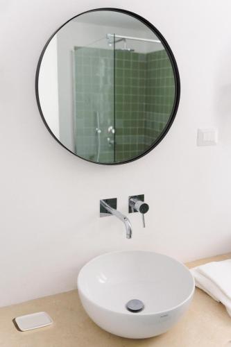 a bathroom with a sink and a mirror on the wall at Casa Veientana in Labaro