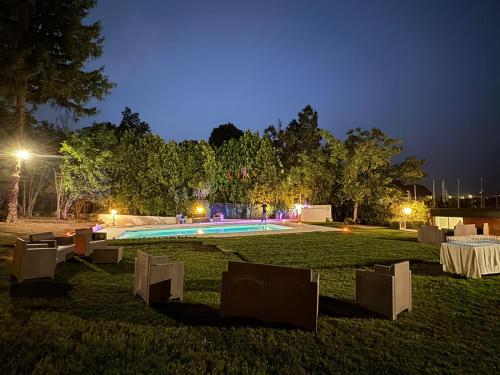 a swimming pool in the middle of a park at night at Casa Veientana in Labaro