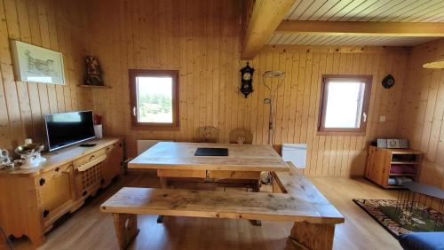 a wooden room with a wooden table and a tv at Chalet Bergtraum in Eischoll