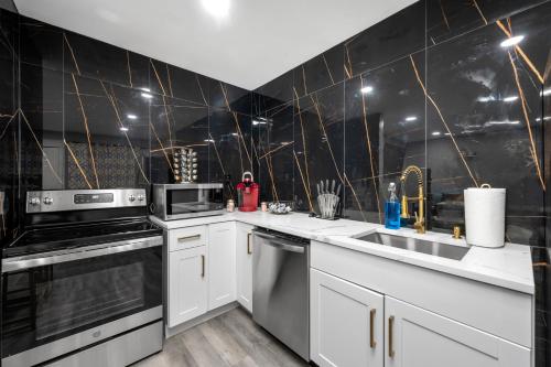 a kitchen with white appliances and black tiles at Cozy 1BR King Bed with Pool and Free Park in Houston