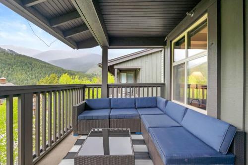 a screened in porch with a couch and a table at Reach Your Peak, Ski In, Ski Out, Pool, Hot Tub in Panorama