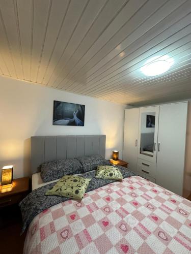 a bedroom with a large bed with two pillows at Apartment Mare in Poreč