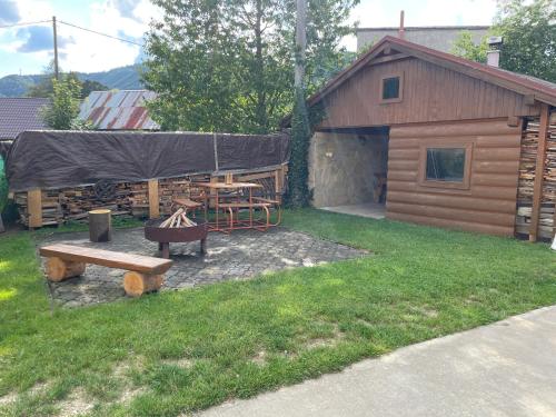 a patio with a picnic table and a cabin at Ubytovanie na Pánskej in Terchová