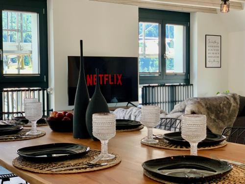 a dining room table with plates and dishes on it at Dora o wellness o mountainview o lake Lucerne in Ingenbohl