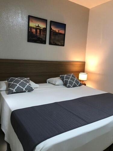 a bedroom with a large bed with two pillows at Abolição Praia Hotel in Fortaleza