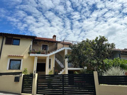 a house with a fence in front of it at Apartment Mare in Poreč
