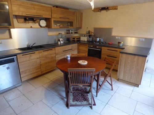 a kitchen with a wooden table and a table and chairs at Maison de charme à 500m du port in Paimpol