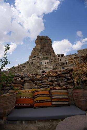 a pile of pillows in front of a mountain at Potamia Cave Suites in Ortahisar