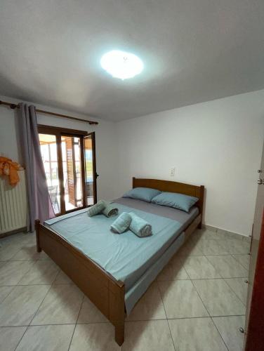a bedroom with a bed with two pillows on it at Maison Olga in Valanidorachi