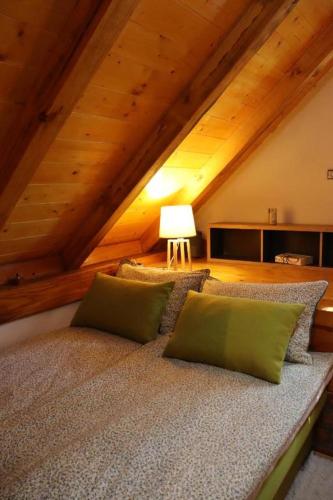 a bed with two pillows on it in a attic at PodRoom Irena in Zmajevac