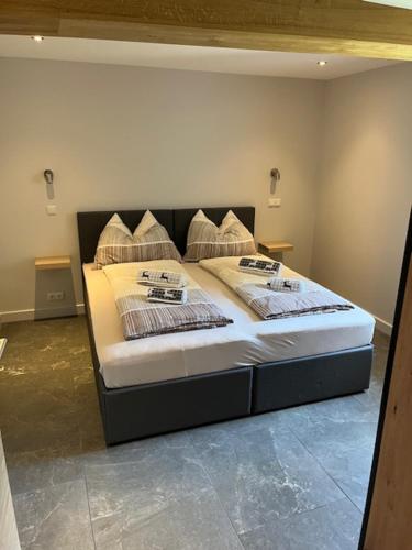 a bedroom with a bed with two pillows on it at Haus Wolfsbach in Rennweg
