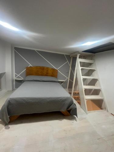 a bedroom with a bed and a staircase at a cas è Angela in Naples