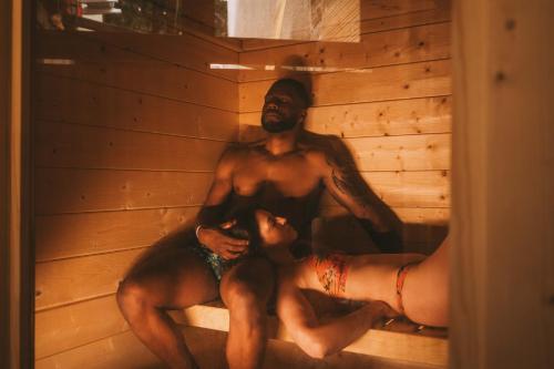a man and a woman laying in a sauna at Centara Spa vichy in Vichy