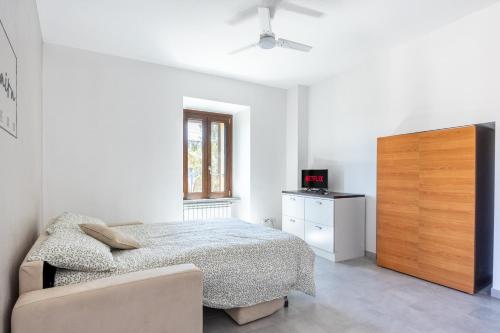 a bedroom with a bed and a wooden dresser at Ca'Maira Dronero in Dronero
