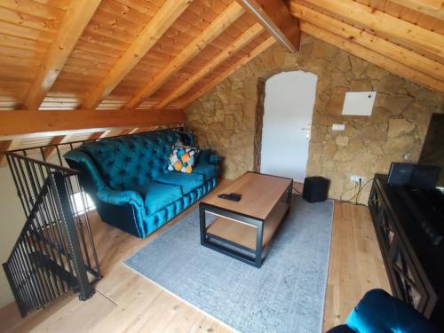 a living room with a blue couch and a table at Casa do Vô Sousa in Pombal