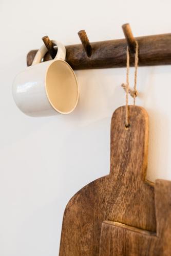 a wooden coat rack with a toilet paper holder at Villa Robs - Appartements tout confort, TV connectée, Haut débit, Localisation idéale - Courts séjours & Affaires in Caen