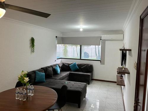 a living room with a couch and a table at Disfruta Boca del Rio in Boca del Río