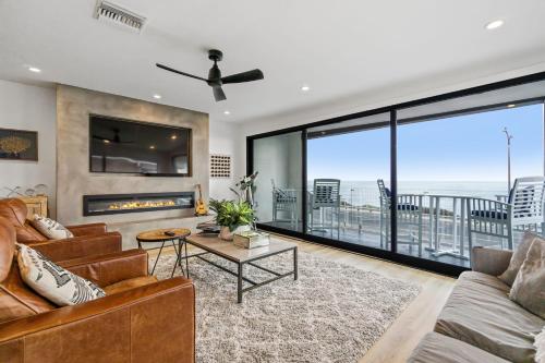 a living room with a couch and a fireplace at Private Beachside Home with HotTub in Carlsbad