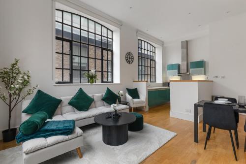 a living room with a couch and a table at Central London, Kings Cross, Minutes From Station! in London