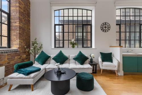 a living room with a couch and a table at Central London, Kings Cross, Minutes From Station! in London