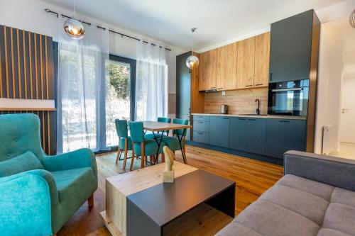a living room with a couch and a table at Aparthotel Phoenix in Bjelašnica