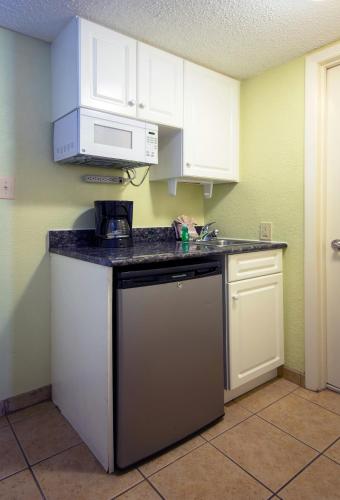 a kitchen with white cabinets and a dishwasher at Compass Cove in Myrtle Beach