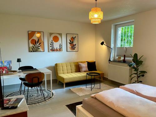 a living room with a couch and a table at Villa Waldeck - Im Kurviertel von Überlingen in Überlingen