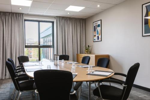 a conference room with a table and chairs at voco Belfast by IHG in Belfast
