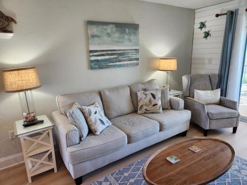 a living room with a couch and a chair at 202 - Adorable 1 bedroom unit - sleeps 6 in Edgewater