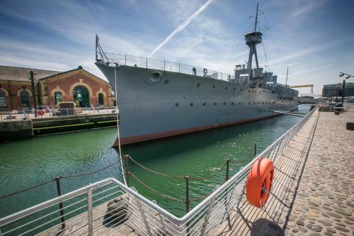 a large ship is docked in the water at voco Belfast by IHG in Belfast