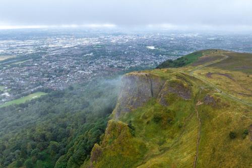 an aerial view of a mountain with a city at voco Belfast by IHG in Belfast