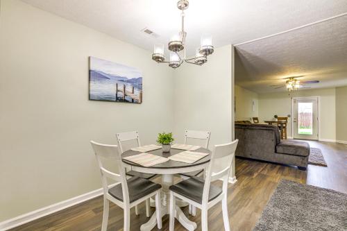 a dining room with a table and chairs and a couch at Convenient Dayton Condo with Grill 4 Mi to Downtown in Dayton