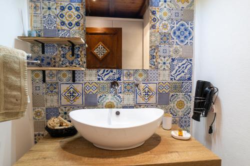a bathroom with a large white bowl sink on a counter at Casa Vacanze Verdemare con Piscina in Ribera